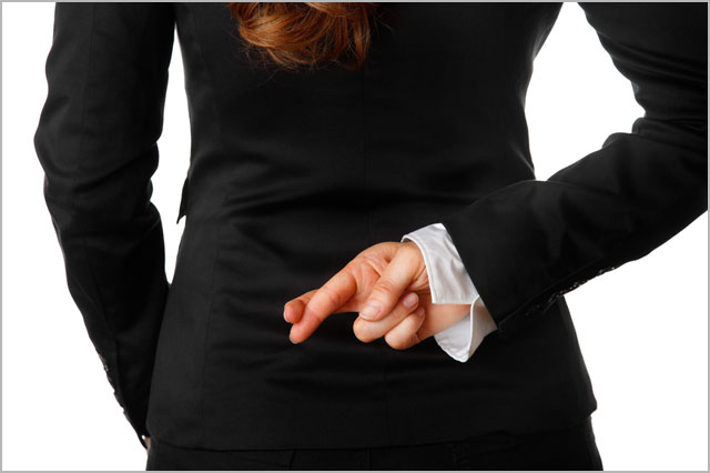 modern business woman holding crossed fingers behind back