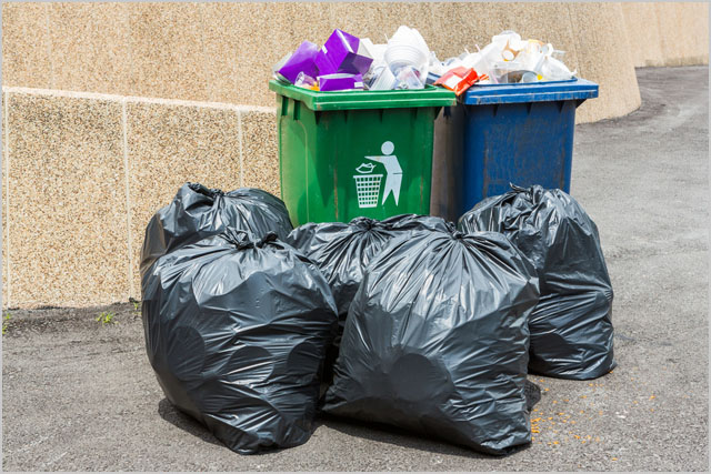 Trash bin and black garbage bag